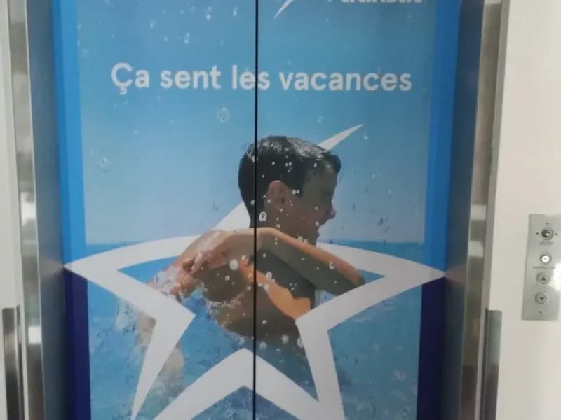 Elevator doors wrapped with Air Transat artwork