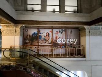 Large Cozey banner hung inside a shopping mall