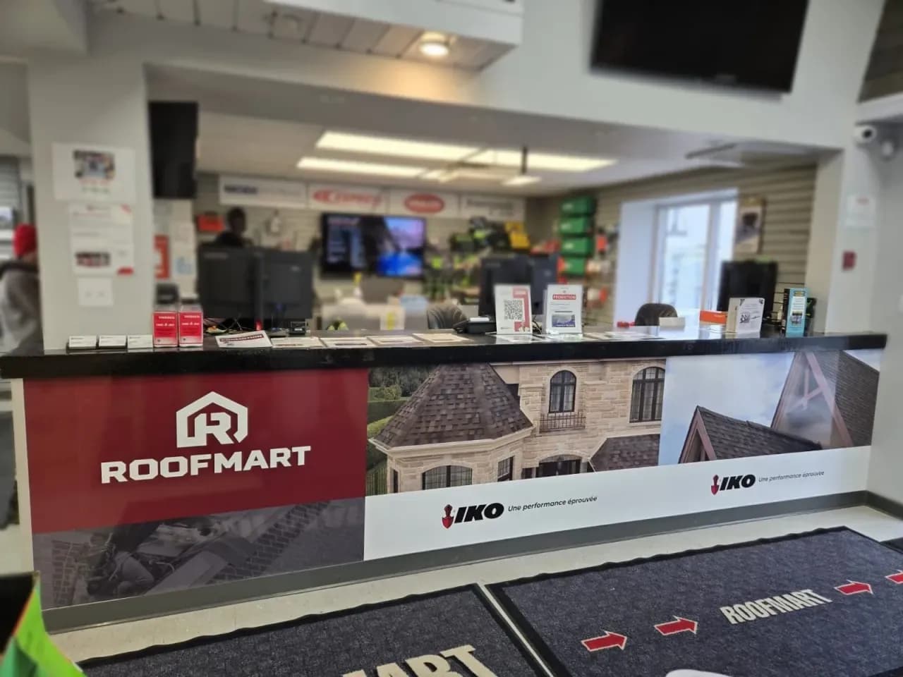 Roofmart service counter wrapped with graphics, with floor direction arrows