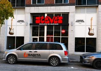 Steve’s Music Store windows with graphics, Sagita van parked in front
