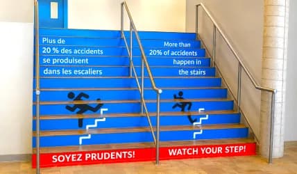 Bilingual safety graphics applied to stair risers
