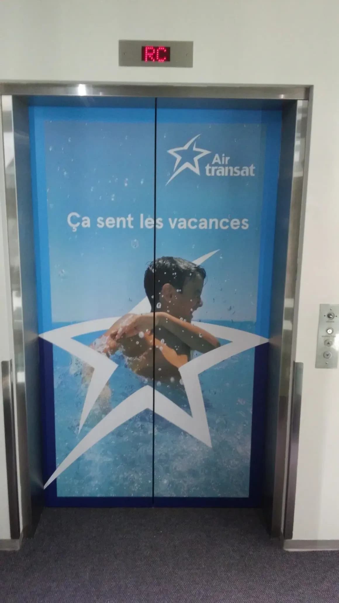 Elevator doors wrapped with Air Transat artwork