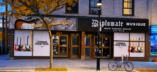 Diplomate Musique storefront windows with guitar graphics