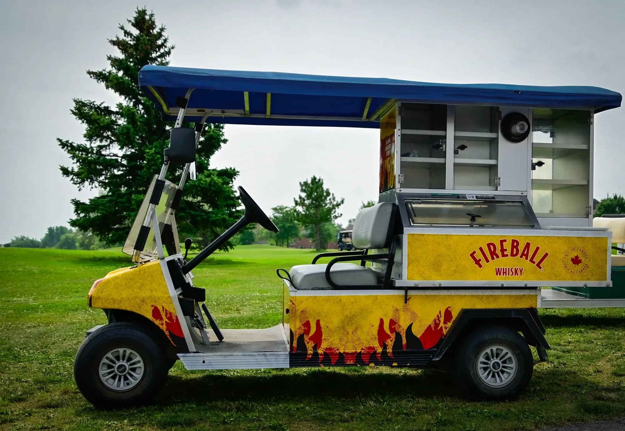 Beverage cart wrapped in Fireball Whisky graphics on a golf course