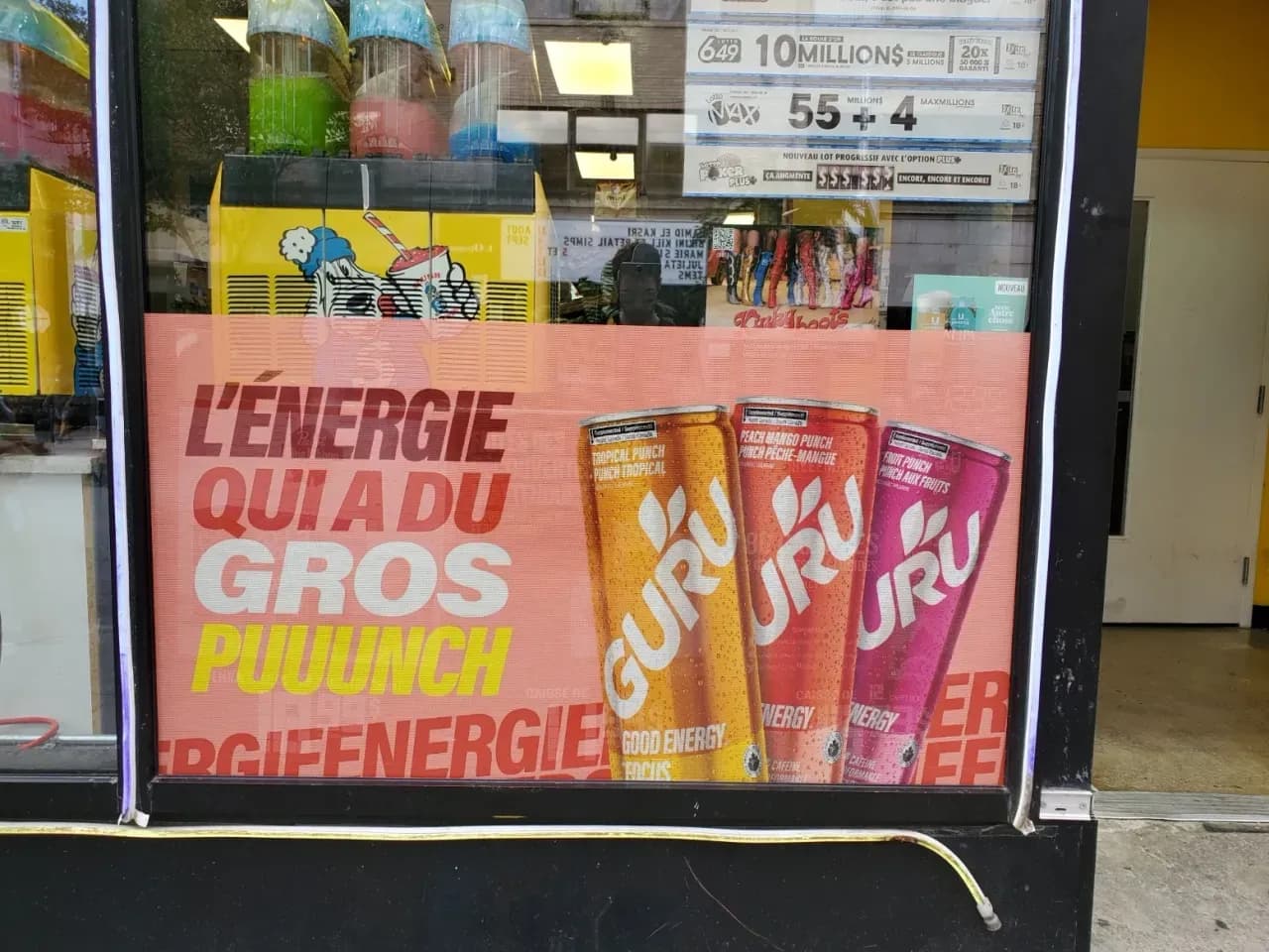 Convenience store window with perforated GURU promotional vinyl