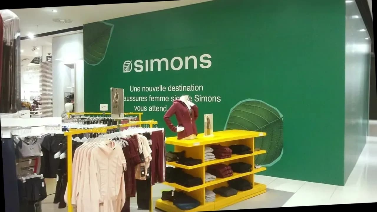 Green interior feature wall with Simons logo and leaf motifs in store